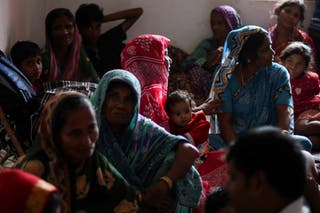 Evacuees from a village in Odisha sit inside a cyclone shelter near Dhamara